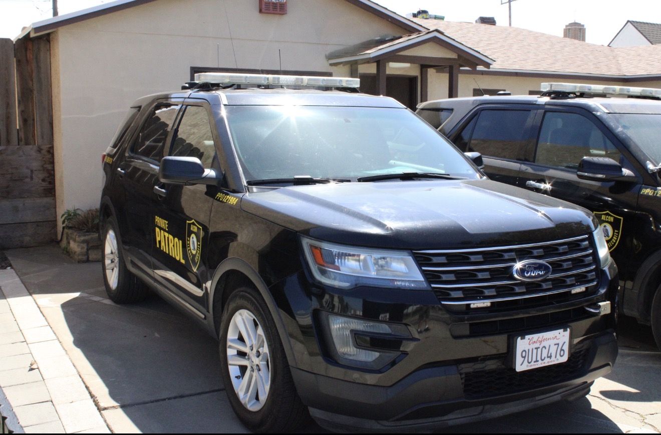 Two Alcon Private Patrol SUVs parked side by side in daylight
